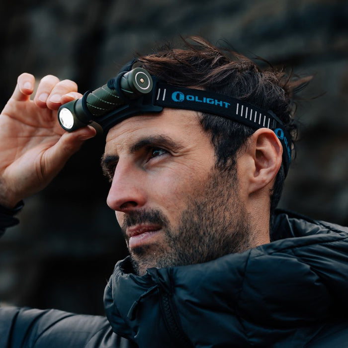 Man wearing Olight Perun 2 headlamp during outdoor adventure